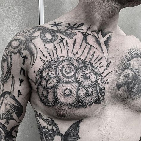 a man with many tattoos on his chest