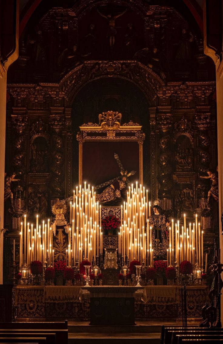 an ornate alter with candles lit up in the background