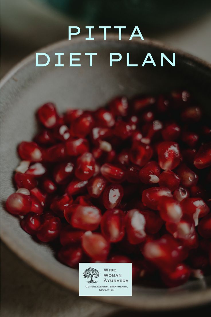 a bowl filled with pomegranate on top of a table