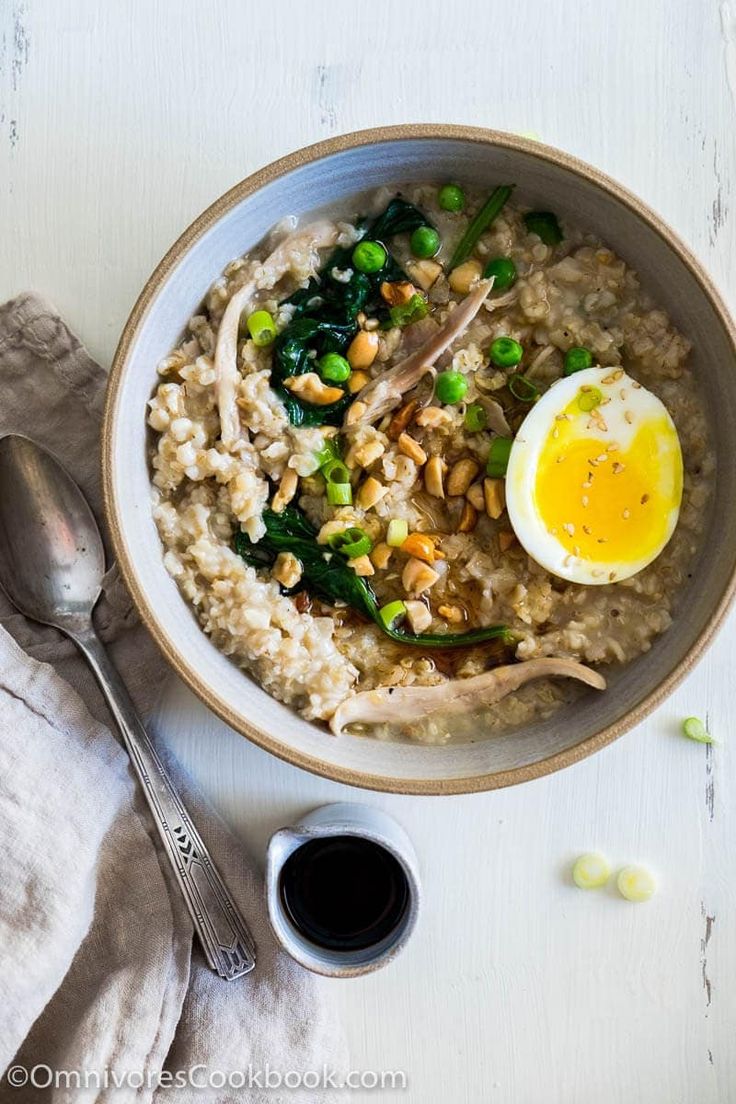 a bowl of oatmeal with an egg on top