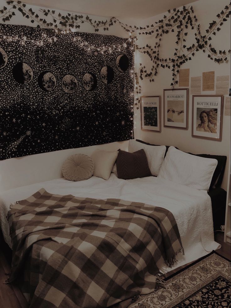 a bed sitting in a bedroom next to a black and white wall with pictures on it