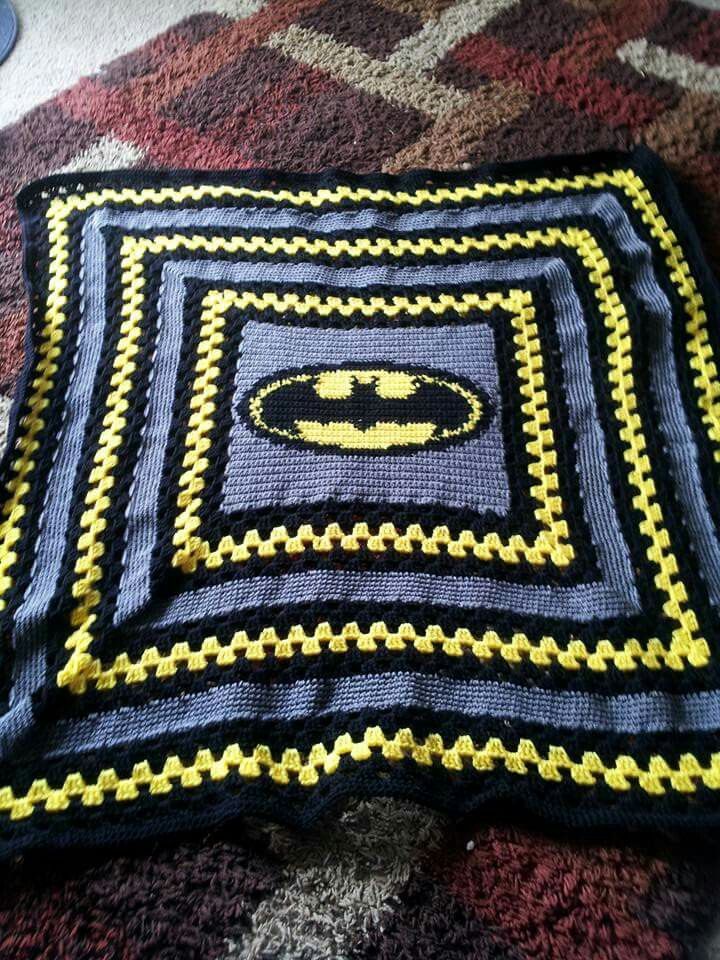 the batman blanket is laying on top of the carpet with it's bat symbol