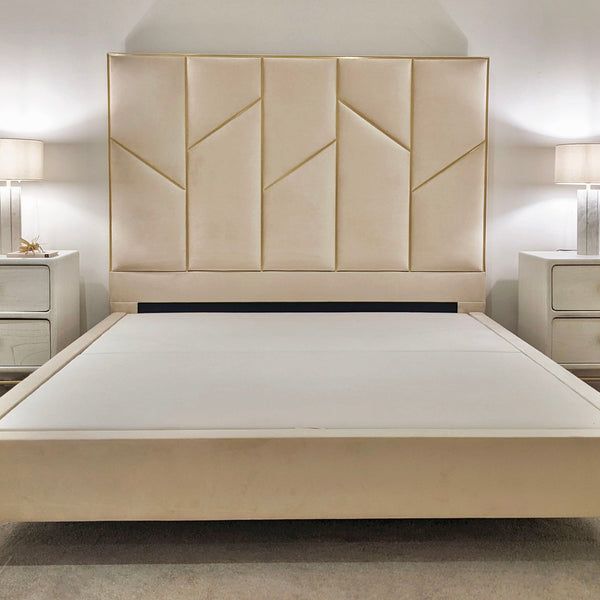 a white bed with beige headboard and night stands