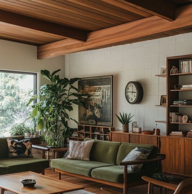 a living room filled with lots of furniture and a plant in the middle of the room