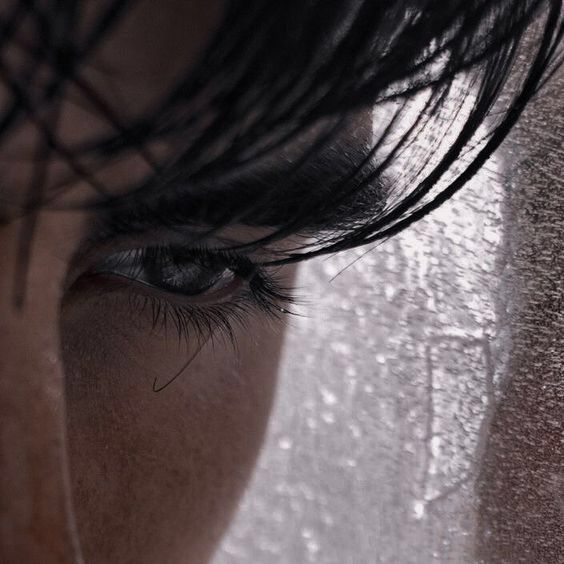 a woman's eyes are covered with water droplets