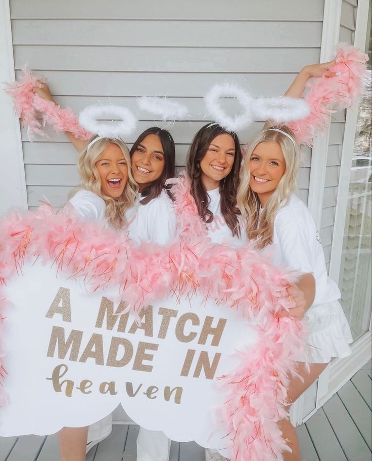 three women dressed in pink and white holding a sign that says, a match made in heaven