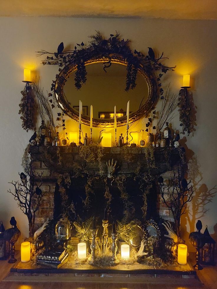 a fireplace with candles lit up in front of it and an ornate mirror on the mantle