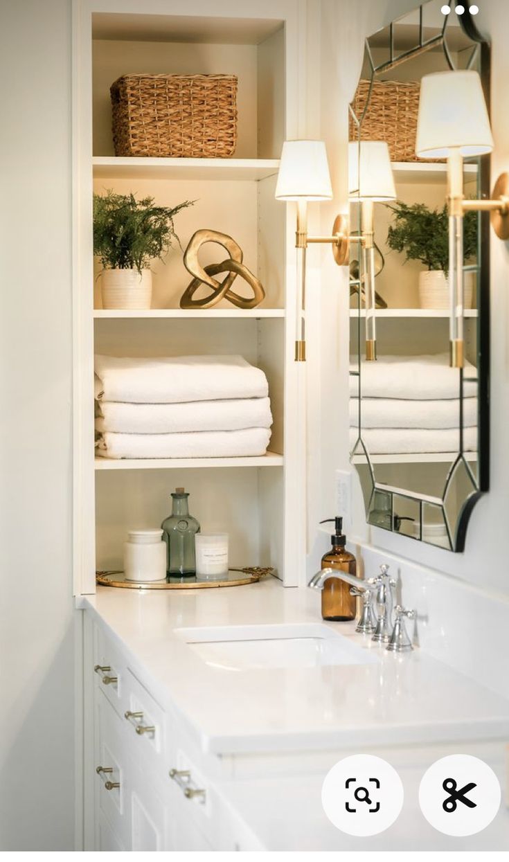 the bathroom is clean and ready to be used as a storage area for folded towels