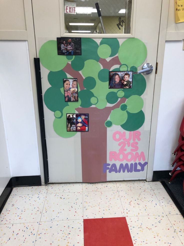 a door decorated with family photos and a tree on the front entrance to an office building