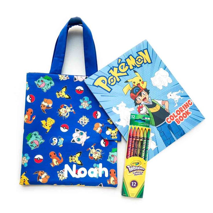 a blue bag with pokemon on it next to a book and pencils