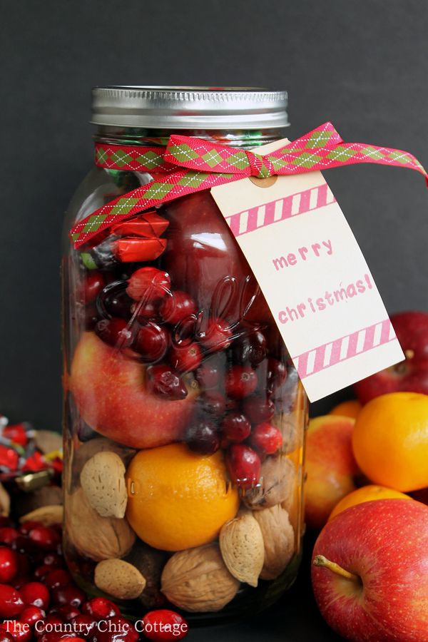 a jar full of fruit and nuts with a merry christmas tag on the front label