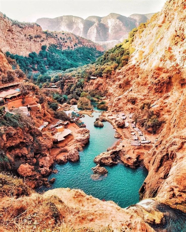 a river in the middle of some mountains