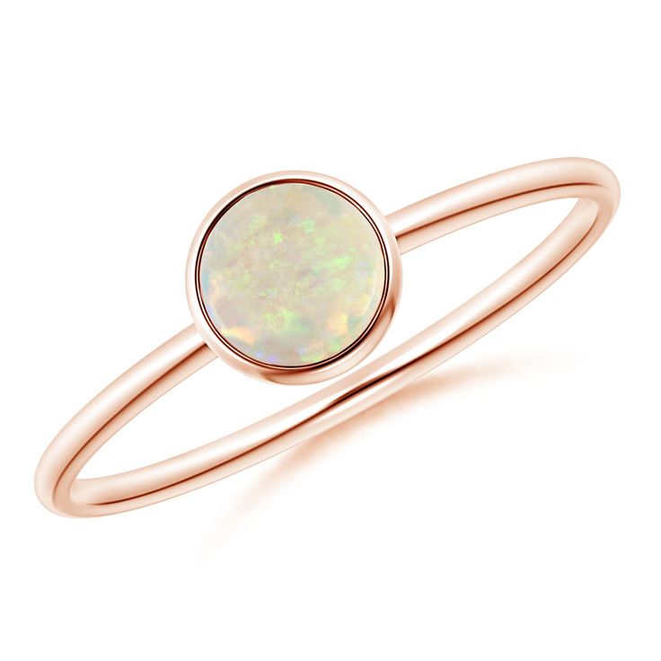 Simple yet elegant, this classic solitaire opal ring is sure to fascinate. The cabochon opal, secured in a bezel setting, allures with its delightful color play. This 14k rose gold round opal ring has a sleek shank that adds to its effortless beauty. Classic Opal Birthstone Ring With Round Band, Formal Opal Birthstone Ring, Classic Round Opal Ring, Opal Cabochon Round Rings, Minimalist Round Cabochon Opal Ring, Elegant Opal Ring With Bezel Setting, Cabochon Opal Round Rings, Formal Minimalist Opal Ring, Classic Rose Gold Opal Ring