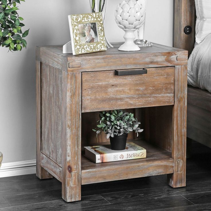 a wooden nightstand with a potted plant on top