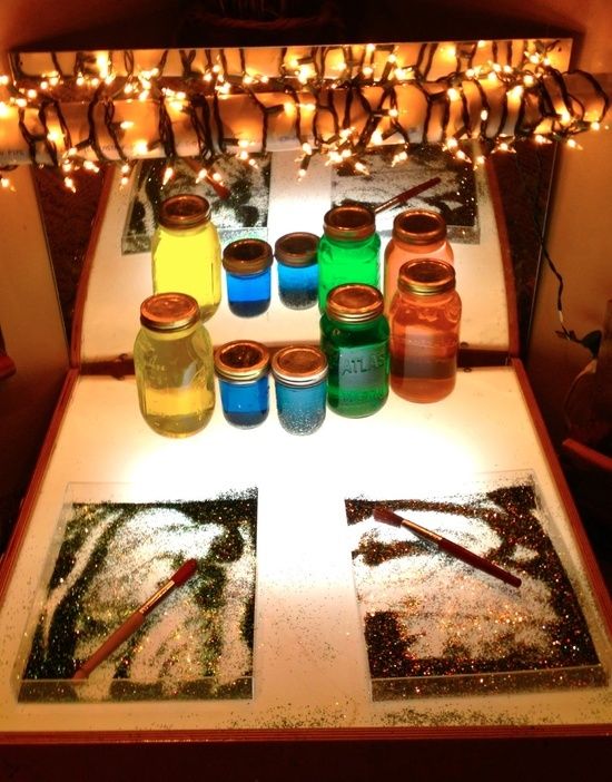 some jars are sitting on a table with candles