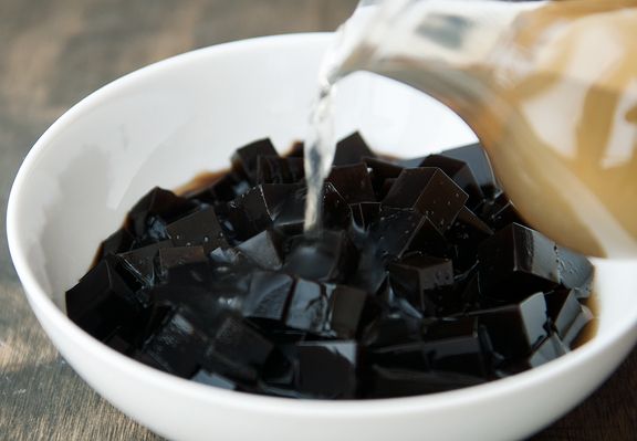 a white bowl filled with chocolate chunks being poured into it