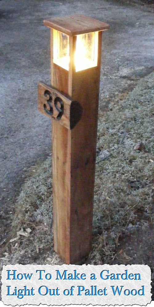 a wooden post with a light on it sitting in the middle of a yard next to a street