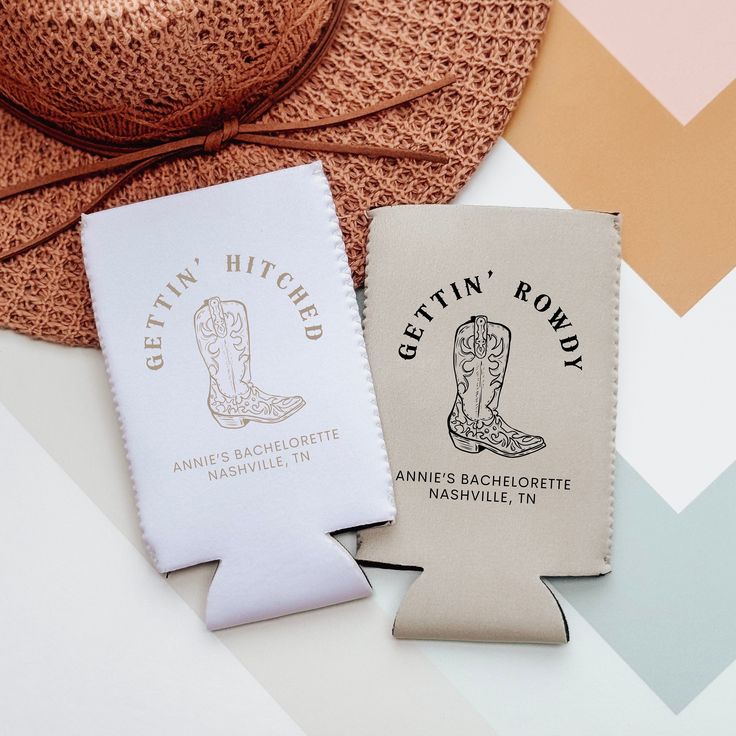 two cloth tags sitting on top of each other next to a hat and cowboy's boot