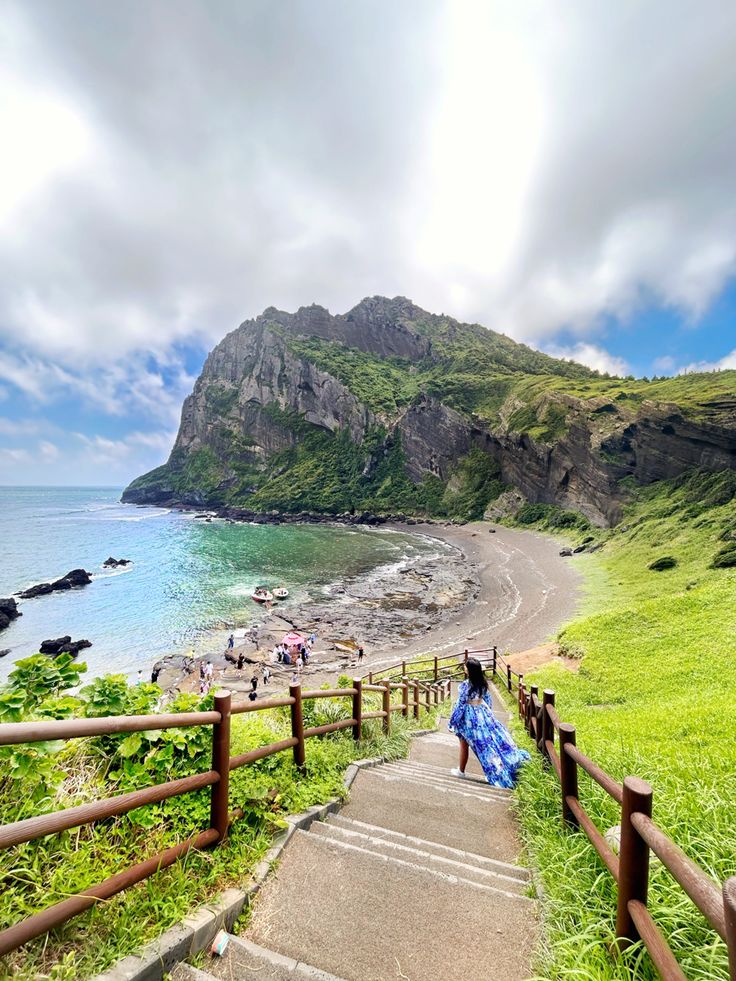 stairs leading down to the beach with people on it