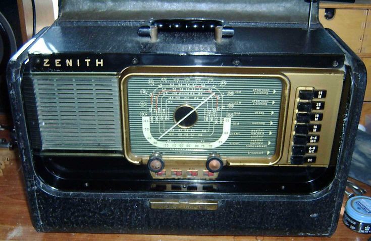 an old radio sitting on top of a wooden table