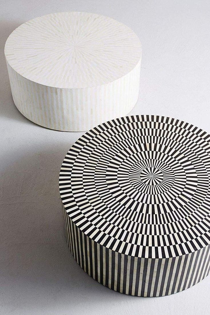 a black and white box sitting on top of a table next to a round object