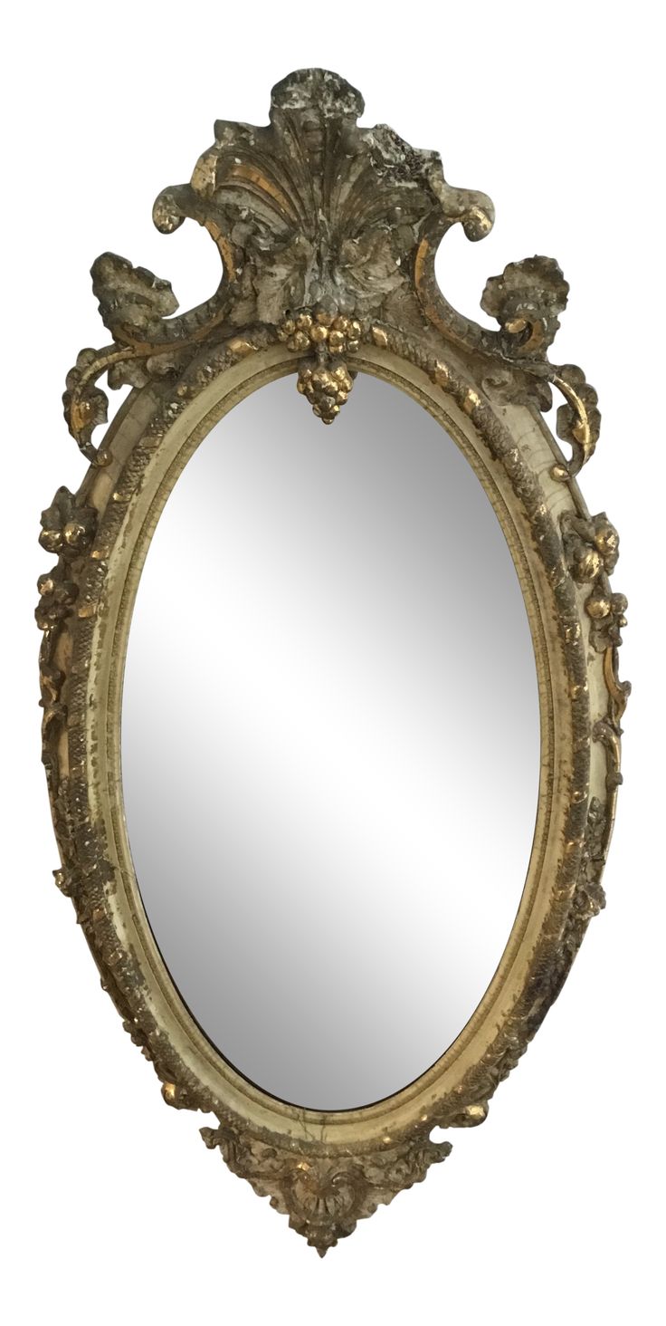 an ornate gold framed mirror against a white background