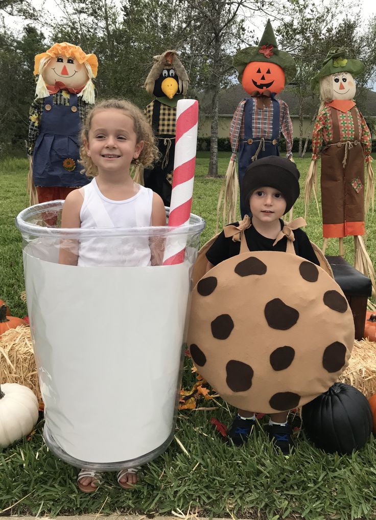 two children in costumes standing next to each other