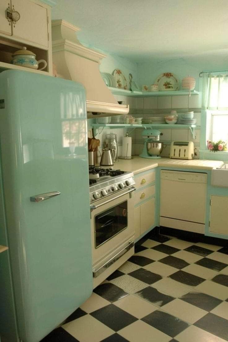 an old fashioned kitchen with checkered flooring and mint green refrigerator freezer combo