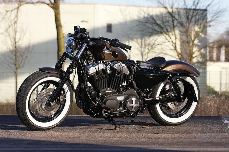 a black and brown motorcycle parked on the street