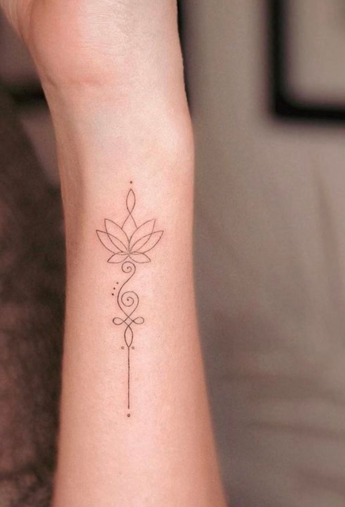 a woman's wrist tattoo with a flower on the left side of her arm