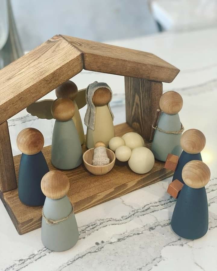 a wooden nativity scene with figurines and eggs