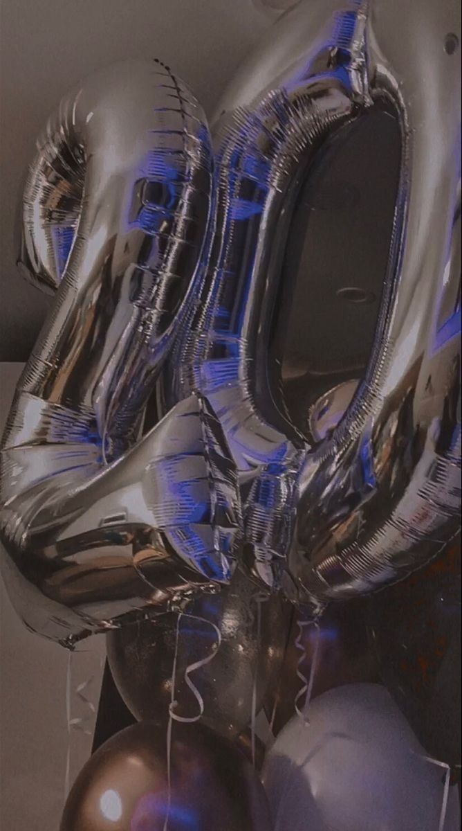 silver balloons with the number twenty on them