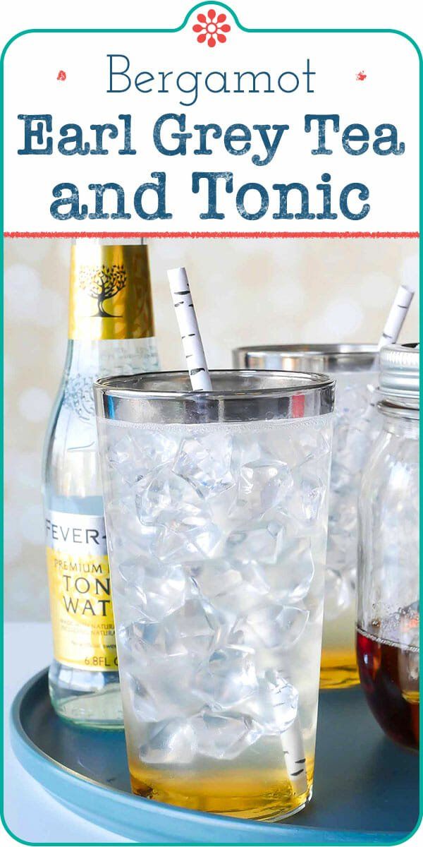 two glasses filled with tea and ice sitting on top of a blue tray next to bottles