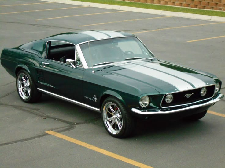 a green mustang parked in a parking lot