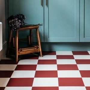 a kitchen with checkered flooring and blue cabinetry in the backround