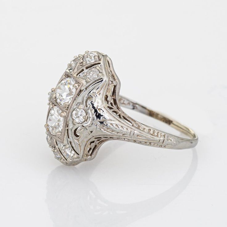 Elegant & finely detailed Belais Art Deco era ring (circa 1920s to 1930s) crafted in 14k white gold.   Two centrally mounted old European cut diamonds are estimated at 0.48 carats each. A further 8 old mine cut diamonds total an estimated 0.42 carats. The total diamond weight is estimated at 1.38 carats (I-J colour and VS2-I2 clarity).      Belais Brothers is a highly regarded and very collectible maker from the late 19th century to the early 20th century. The ring epitomises vintage charm and w 1920 Engagement Ring Vintage, Collectible Platinum Diamond Ring With Brilliant Cut, Antique Platinum Cluster Ring, Art Deco Brilliant Cut Diamond Ring Collectible, Art Deco Collectible Diamond Ring With Brilliant Cut, Collectible Platinum Diamond Ring In Diamond White, Collectible Diamond White Platinum Diamond Ring, Art Deco White Gold Cluster Ring In Platinum, Estate Rose Cut Diamond Jewelry For Anniversary