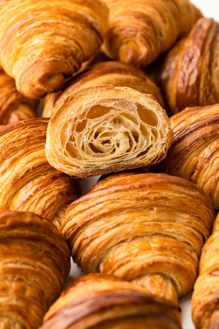 there are many croissants that have been cut in half and stacked on top of each other