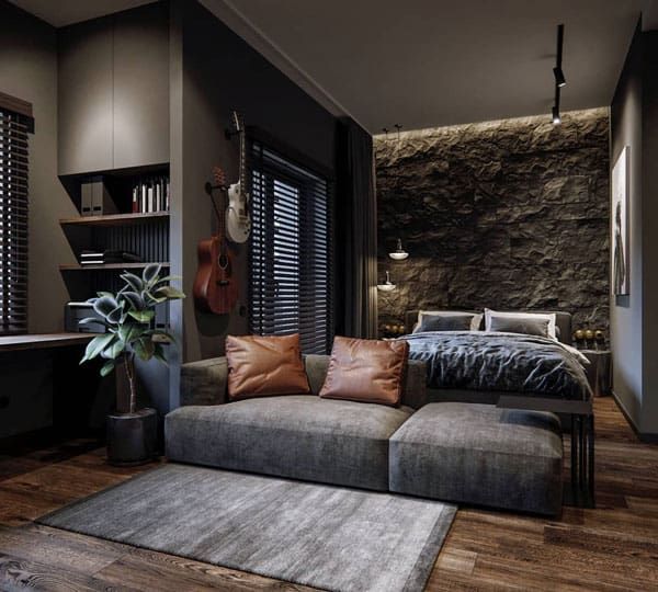 a living room with a couch, table and bookshelf next to a stone wall