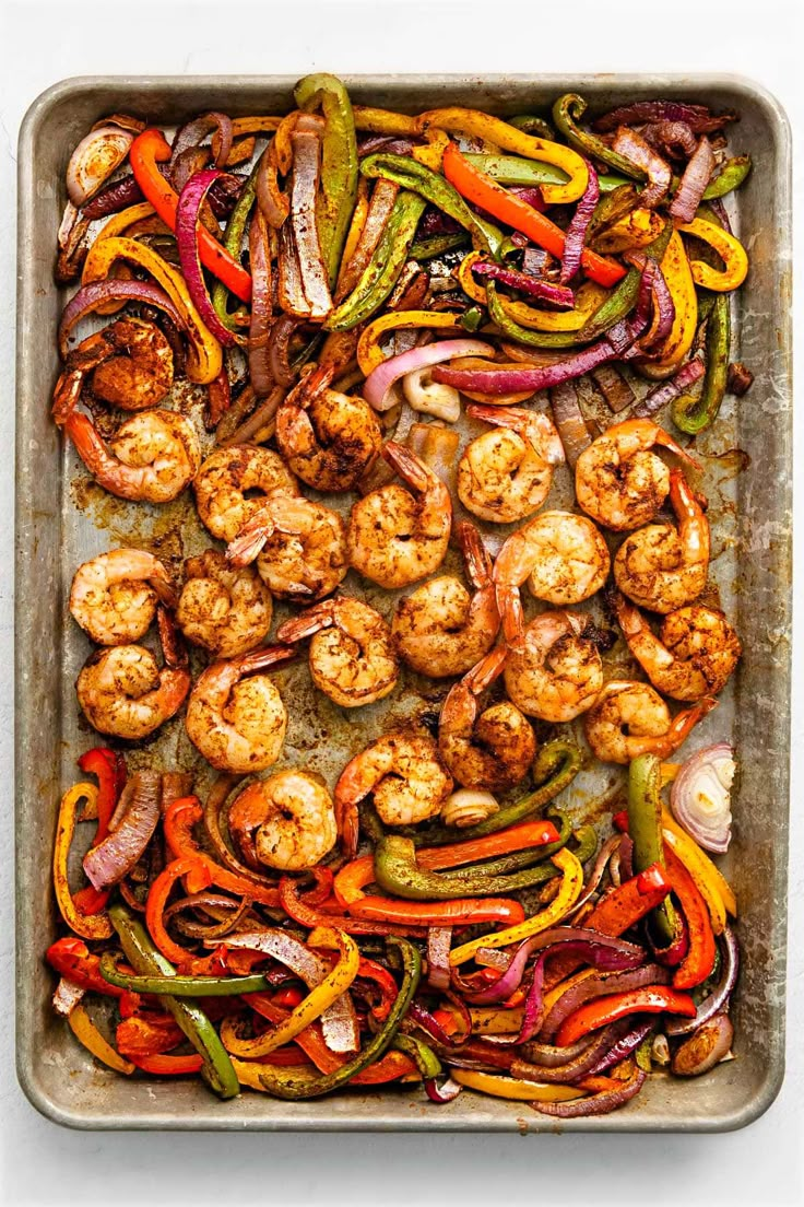 shrimp and peppers on a sheet pan ready to be cooked in the oven for dinner