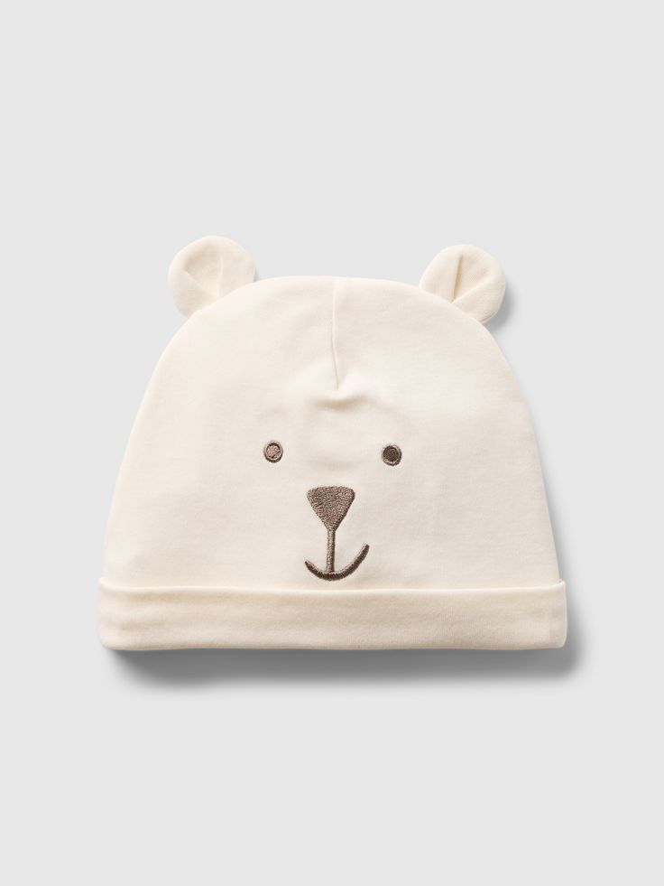 Supersoft Supima® cotton beanie.  Bear appliques at top and front.  100% of the cotton in this hat is verified by the U. S.  Cotton Trust Protocol, a program which works with farms committed to improving their environmental footprint by minimizing water usage and improving soil diversity Claim No.  B6AFDACC-10117).  For more fit and sizing info, check out our Size Guide. Beanie Bears, Cotton Beanie, Bear Hat, Water Usage, Supima Cotton, Toddler Shoes, Appliques, Baby Toddler, Soil