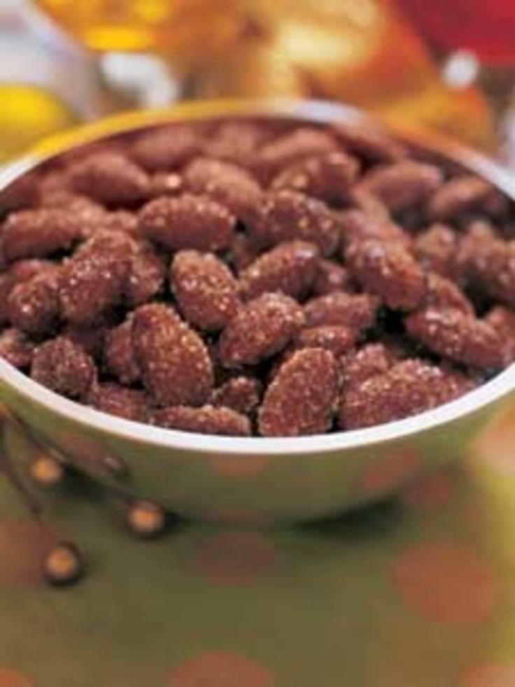 a bowl filled with nuts sitting on top of a table