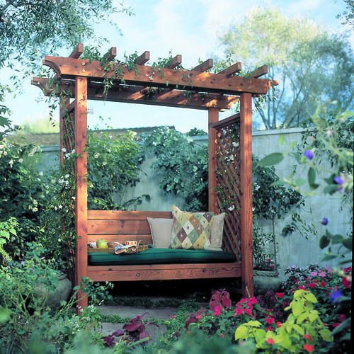 a wooden bench sitting in the middle of a garden