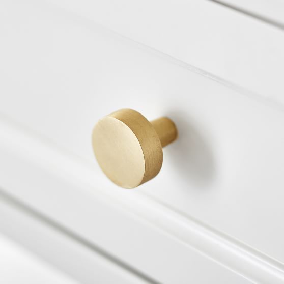 a close up of a knob on a white cabinet