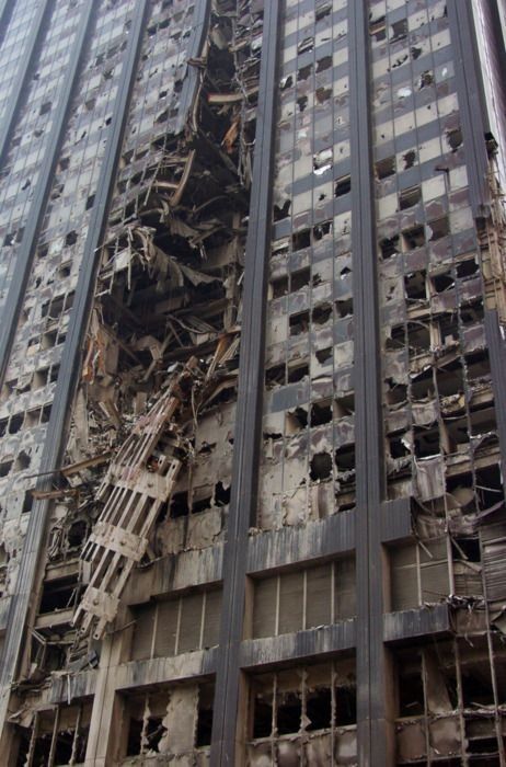 a very tall building with lots of windows and debris all over it's sides