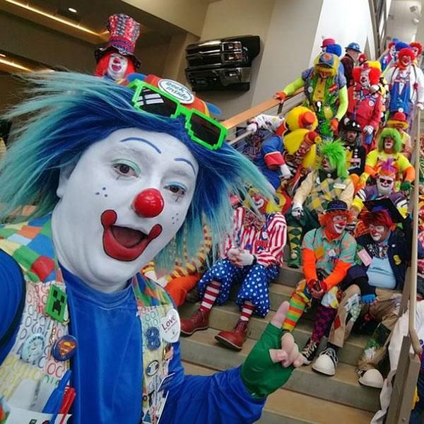 a group of clowns are lined up on the stairs