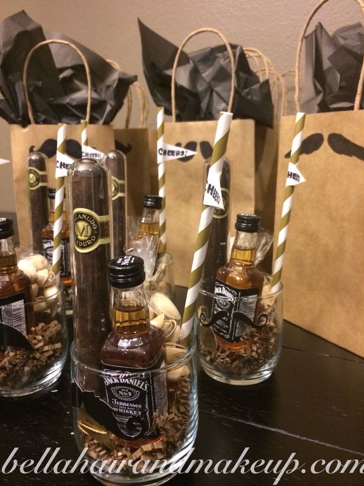 bottles filled with different types of liquor sitting on top of a table next to paper bags