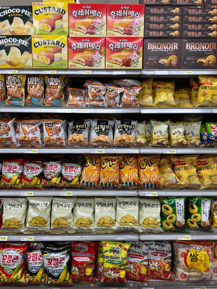 an assortment of snacks are on display in a grocery store's deli shelf