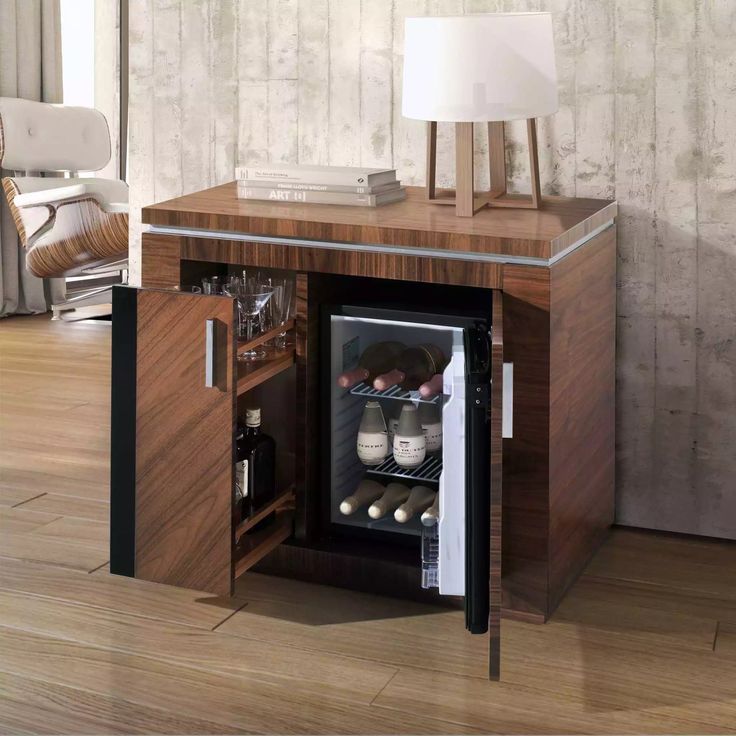 an open wine cooler in the corner of a room