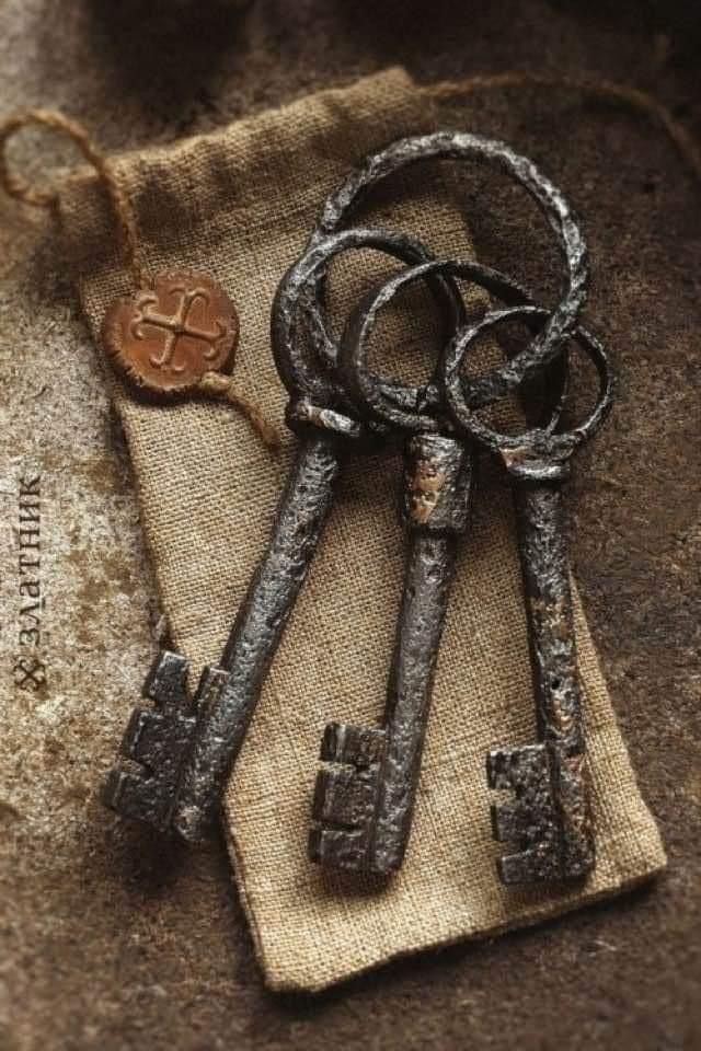 two old keys are sitting on a piece of burlock