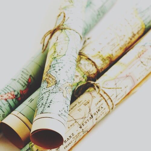 three rolled up maps sitting on top of each other